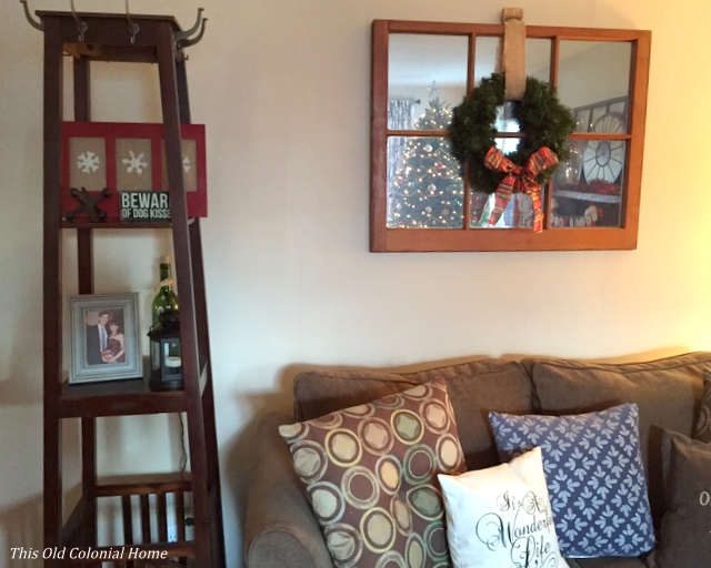 Snowflake sign and Christmas decor in living room 